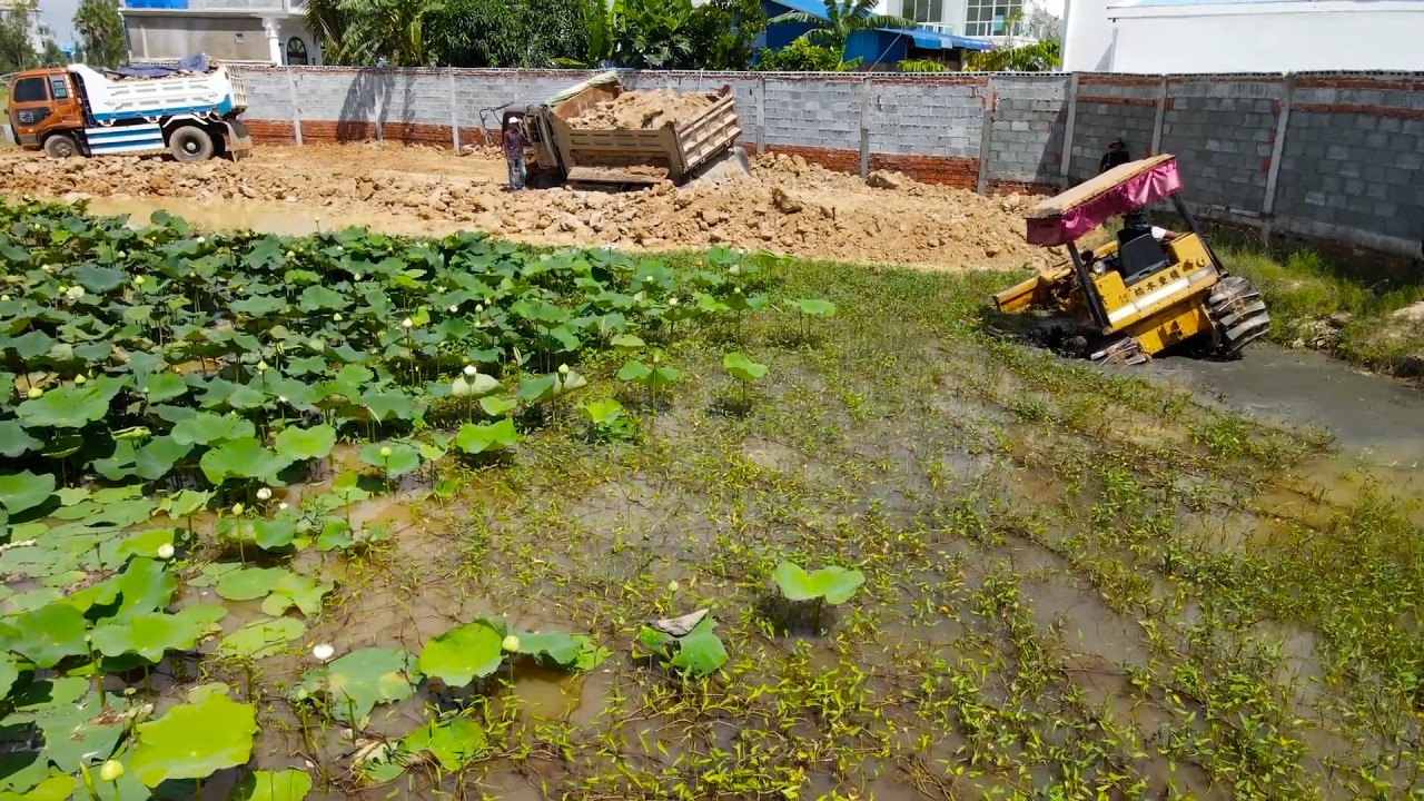 Amazing engineering feat!! The process of transforming  lake into  landfill bulldozer push rocks