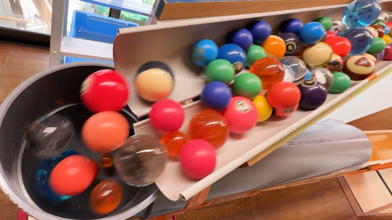 I made a marble run course using a large clay pipe to roll colorful wooden balls and billiard balls.
