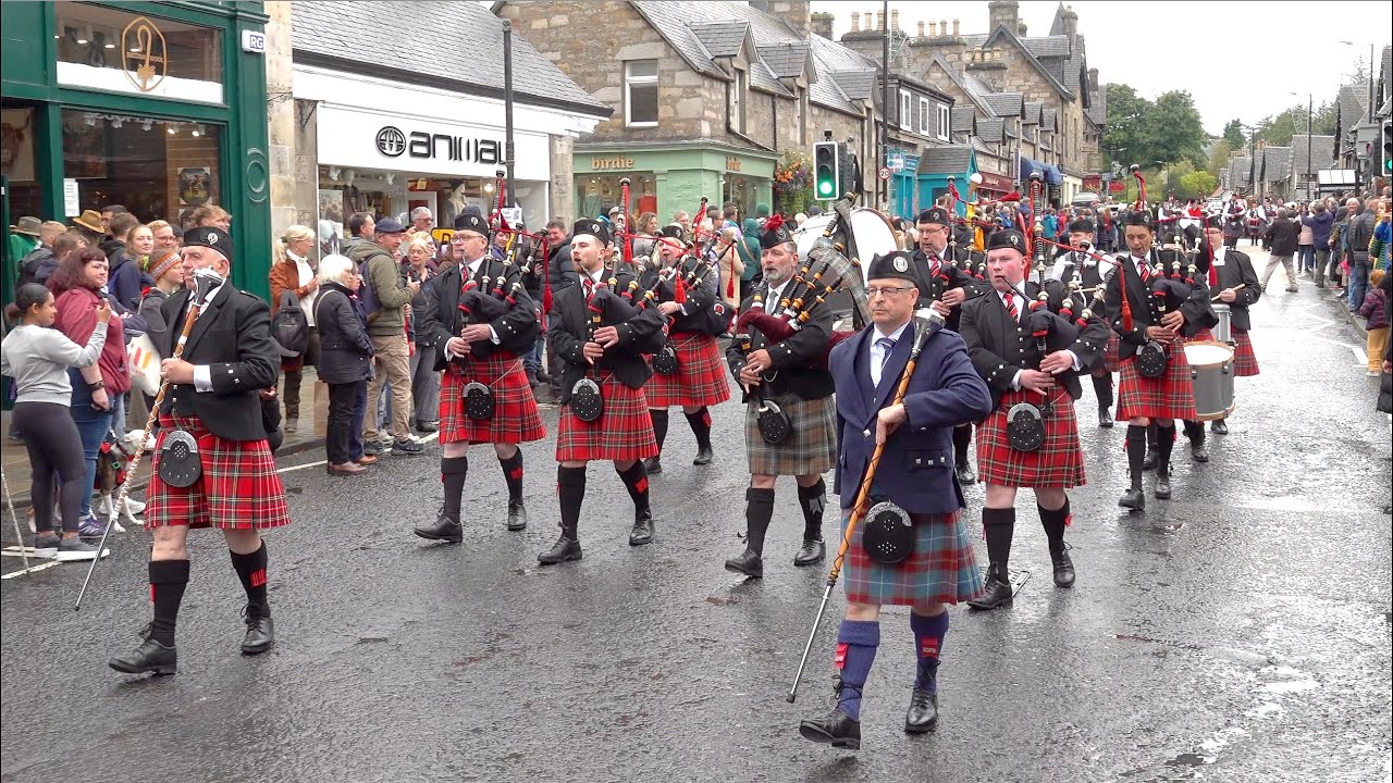 Kilsyth Thistle & Barrhead Pipe Bands in street parade marching to 2024 Pitlochry Highland Games