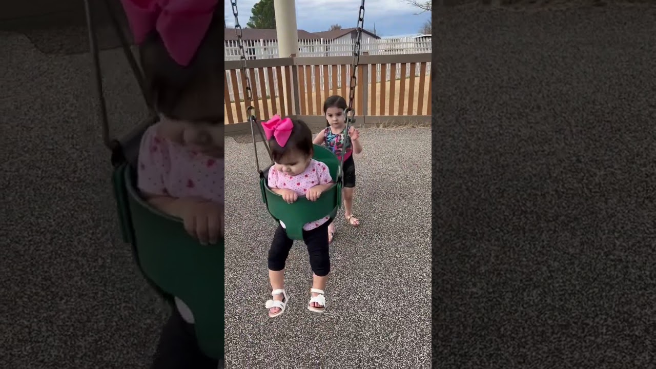 Pushing her sister on the swing #shorts #youtubeshorts #kids #baby #swing #fun #park #playground