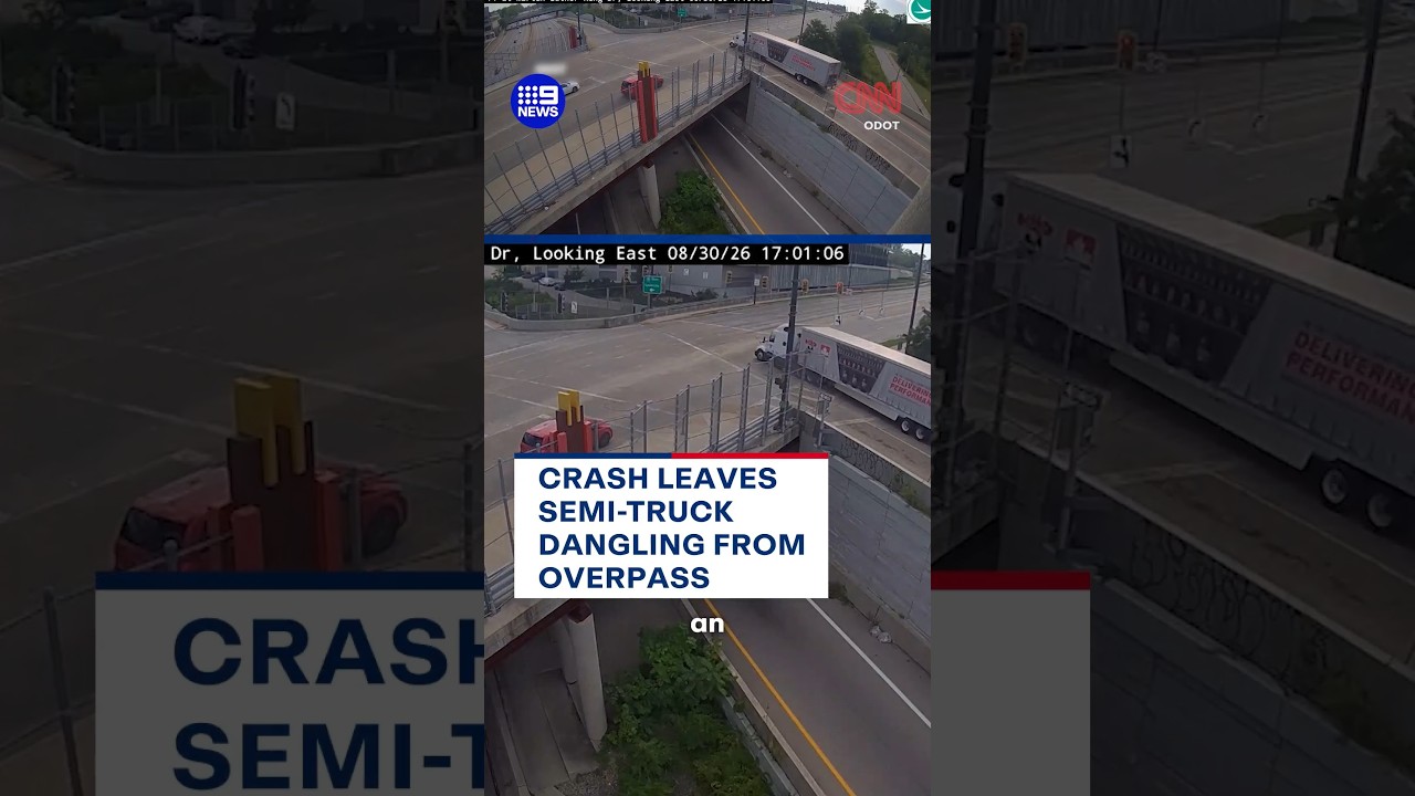Crash leaves semi-truck dangling from overpass | 9 News Australia