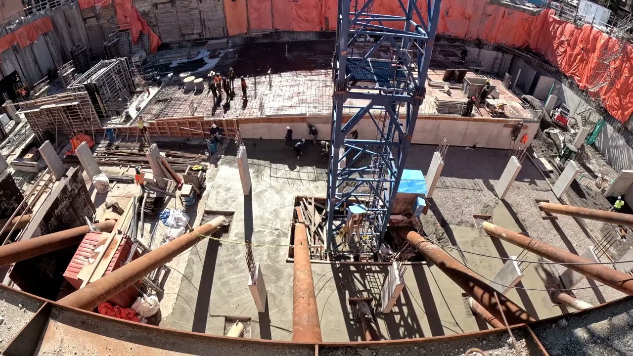 Time-lapse of one day's  construction, underground parking garage slab on grade.