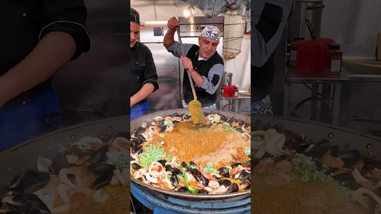 Cooking Big Pan of Rice and Seafood. Italy Street Food