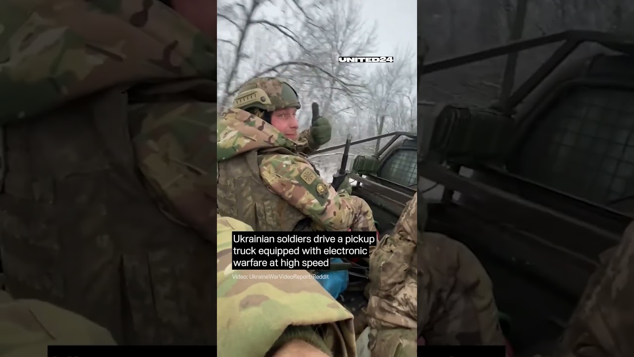 Ukrainian Soldiers Drive a Pickup Truck Equipped With Electronic Warfare 