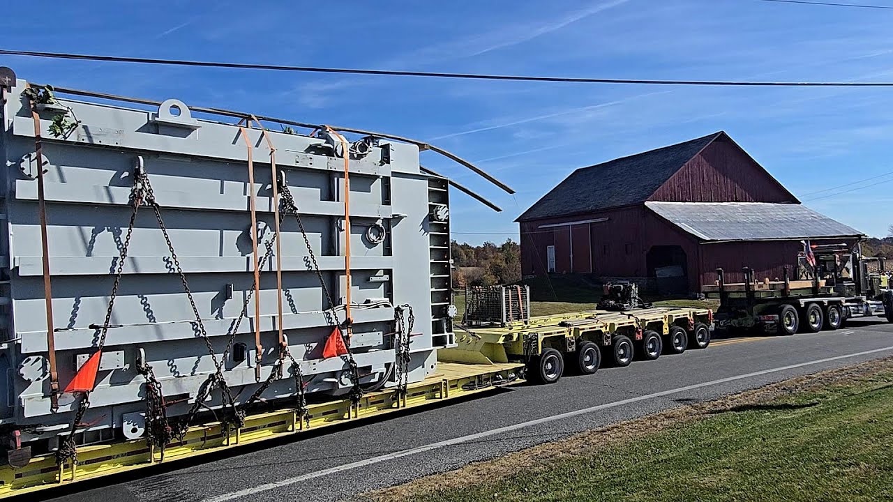 Massive Load Supor Trucking Peterbilt 379 Moving 741,000 Lbs. Transformer 32 Axles  Oshkosh Pusher