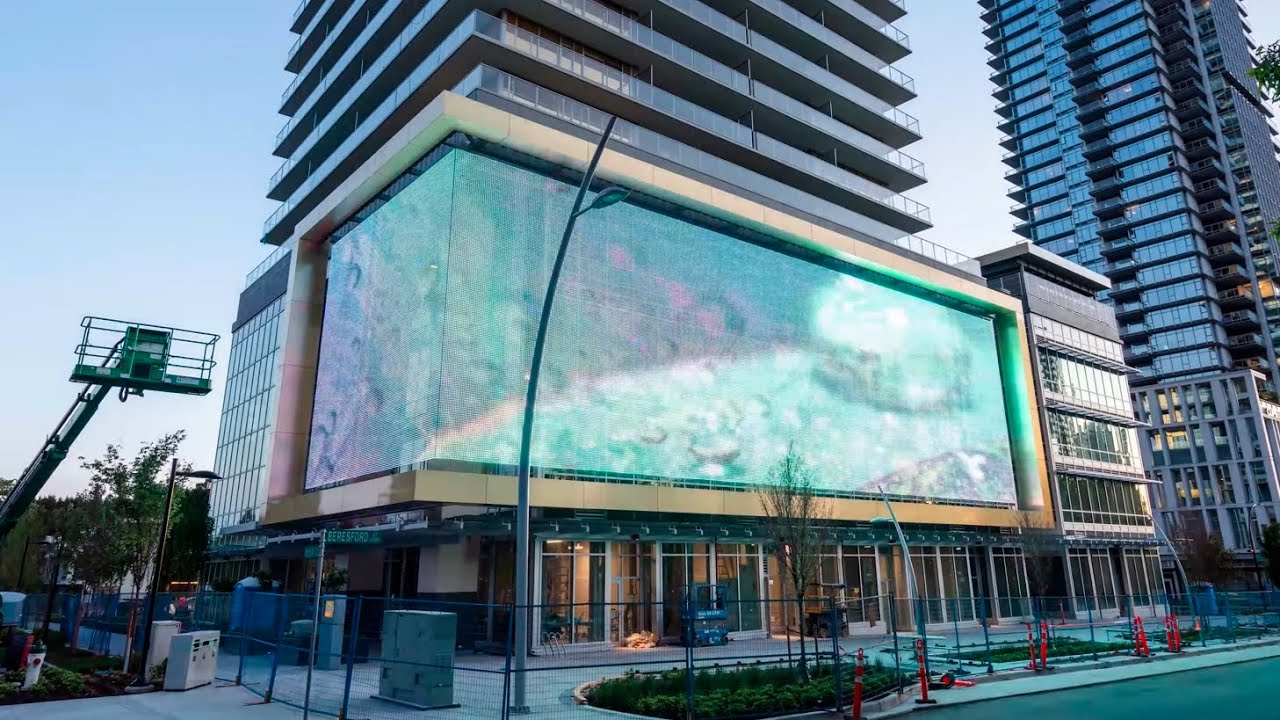 Outdoor LED Mesh Display Transforms Building into North America’s Largest Digital Art Canvas