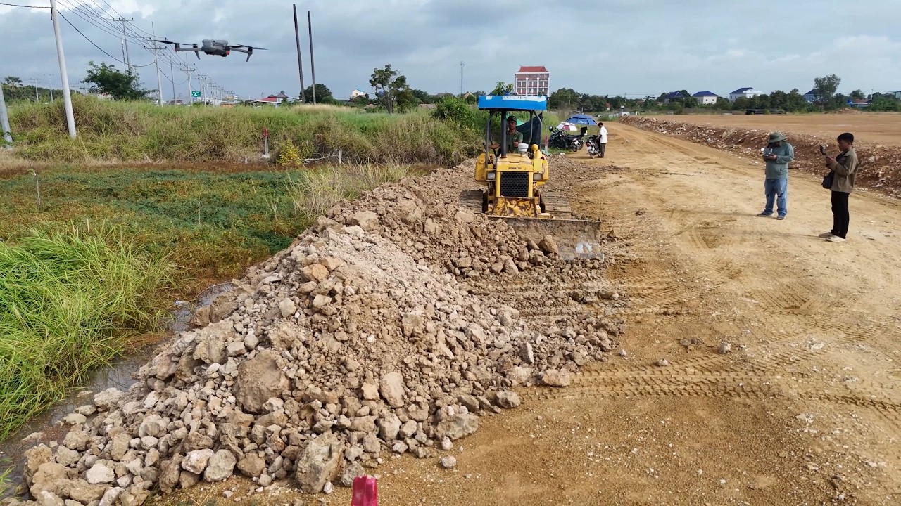 Great teamwork in action! Bulldozers and dump trucks moving soil with perfect coordination.