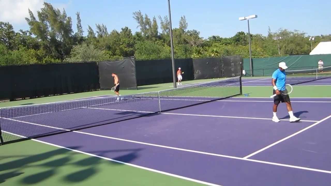 Paes practicing volleys with Llodra