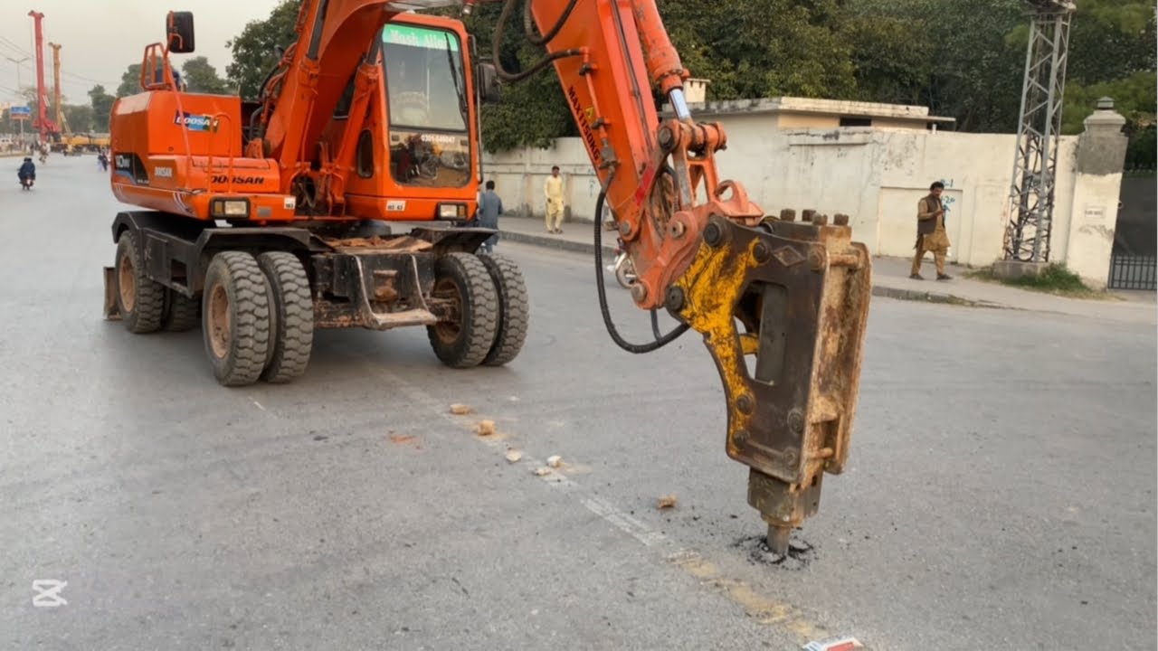 Hydraulic Breaker Working On Asphalt Road 