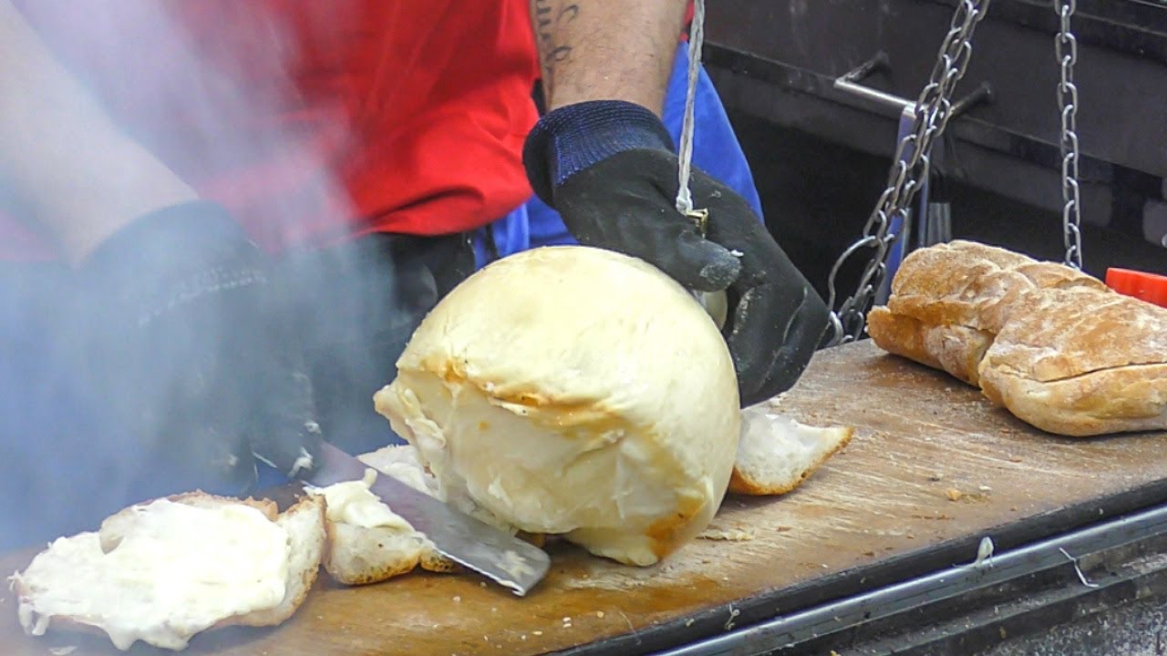 Hanged Cheese 'Caciocavallo' Grilled and Melted on Bread. Italy Street Food