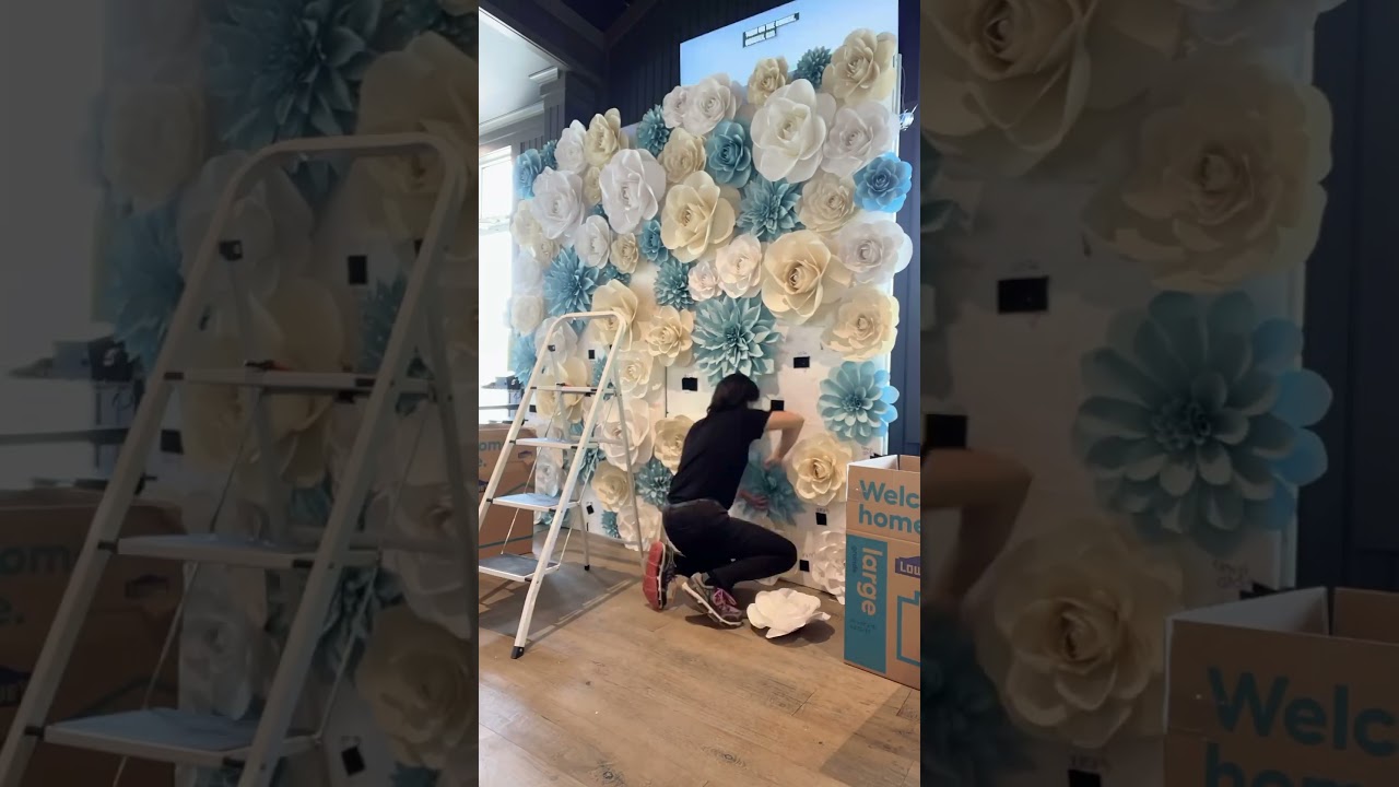 Set up a white, cream and blue paper flower wall, backdrop with me for a wedding 