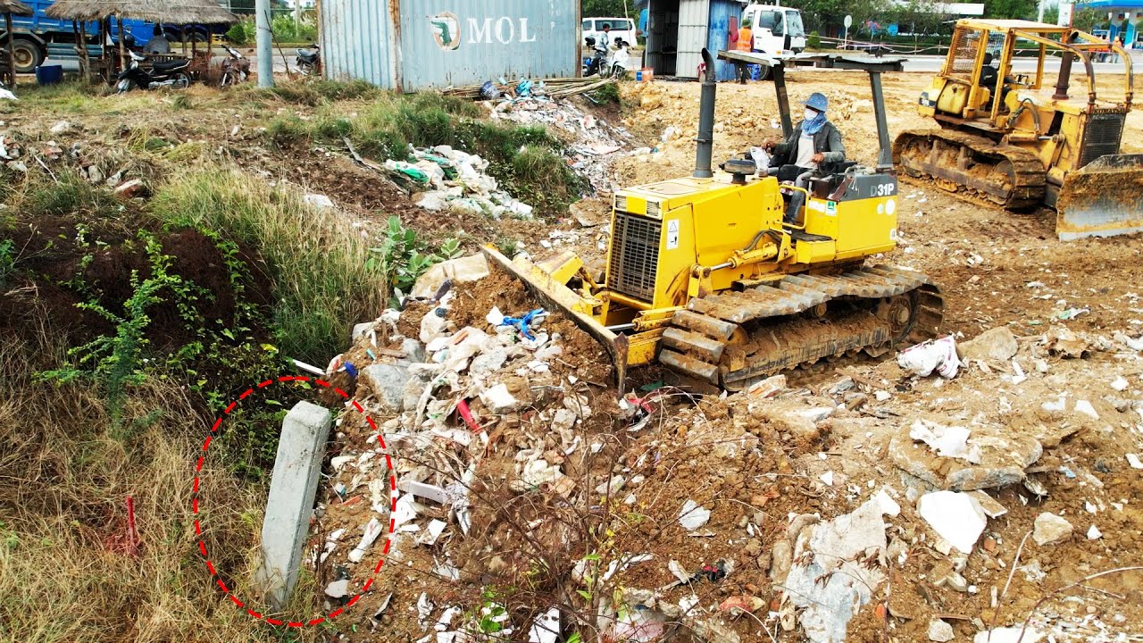 EP5-Expert Operator Komatsu D31P Bulldozer Pushing Trash Heap Connecting To Land Boundary
