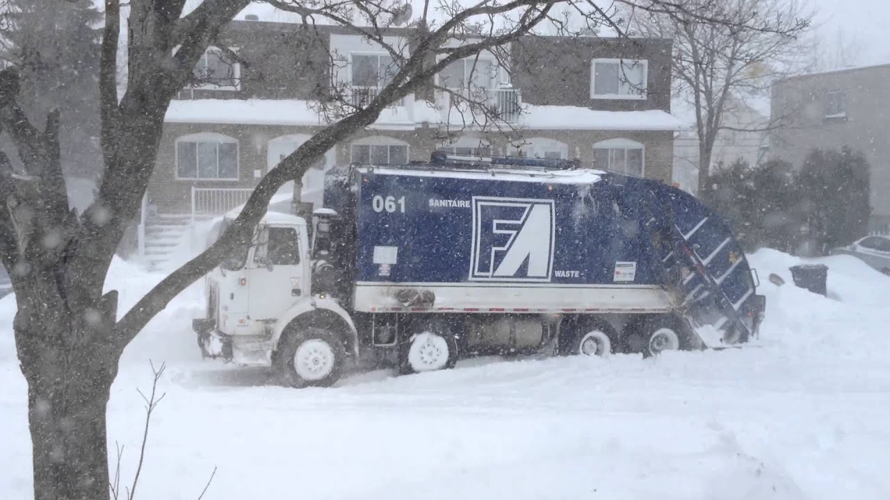 Garbage truck stuck in a snowstorm in montreal, Canada