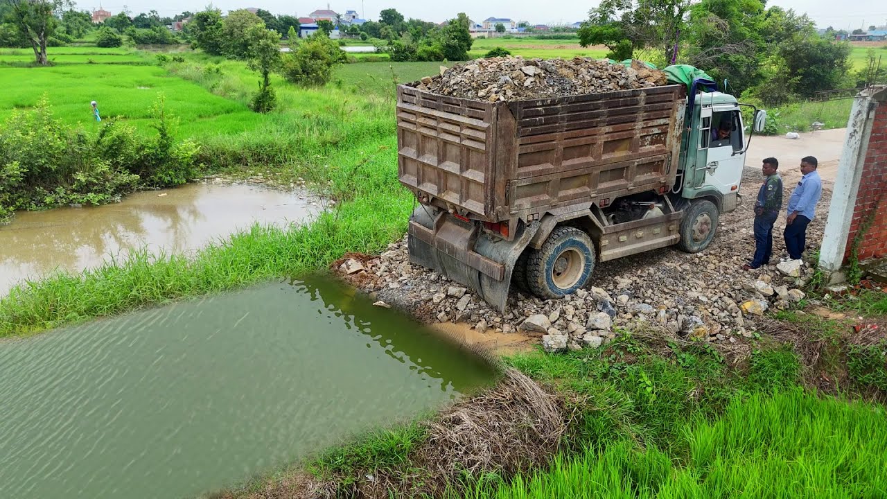 Be Carefully Start New Landfill Task!. Dozer Pushing Stone Paving New Road &Dump Truck 5T Unloading