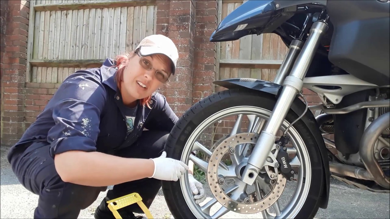 Filling a motorbike tyre with Goop tyre sealant