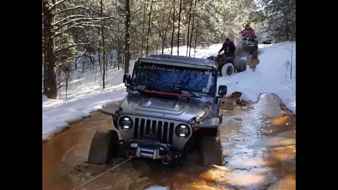 Jeep Rubicon stuck in deep mud. Winch out