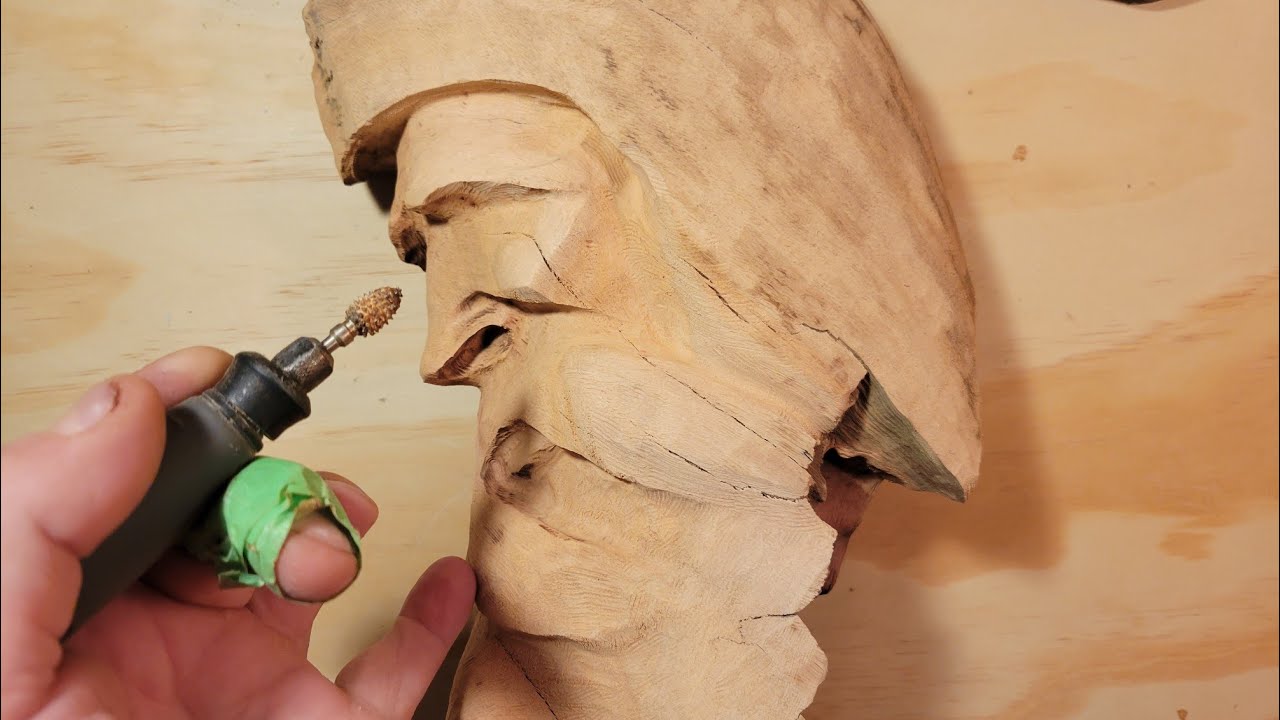 Dremel Carving A side view Wood spirit on driftwood.