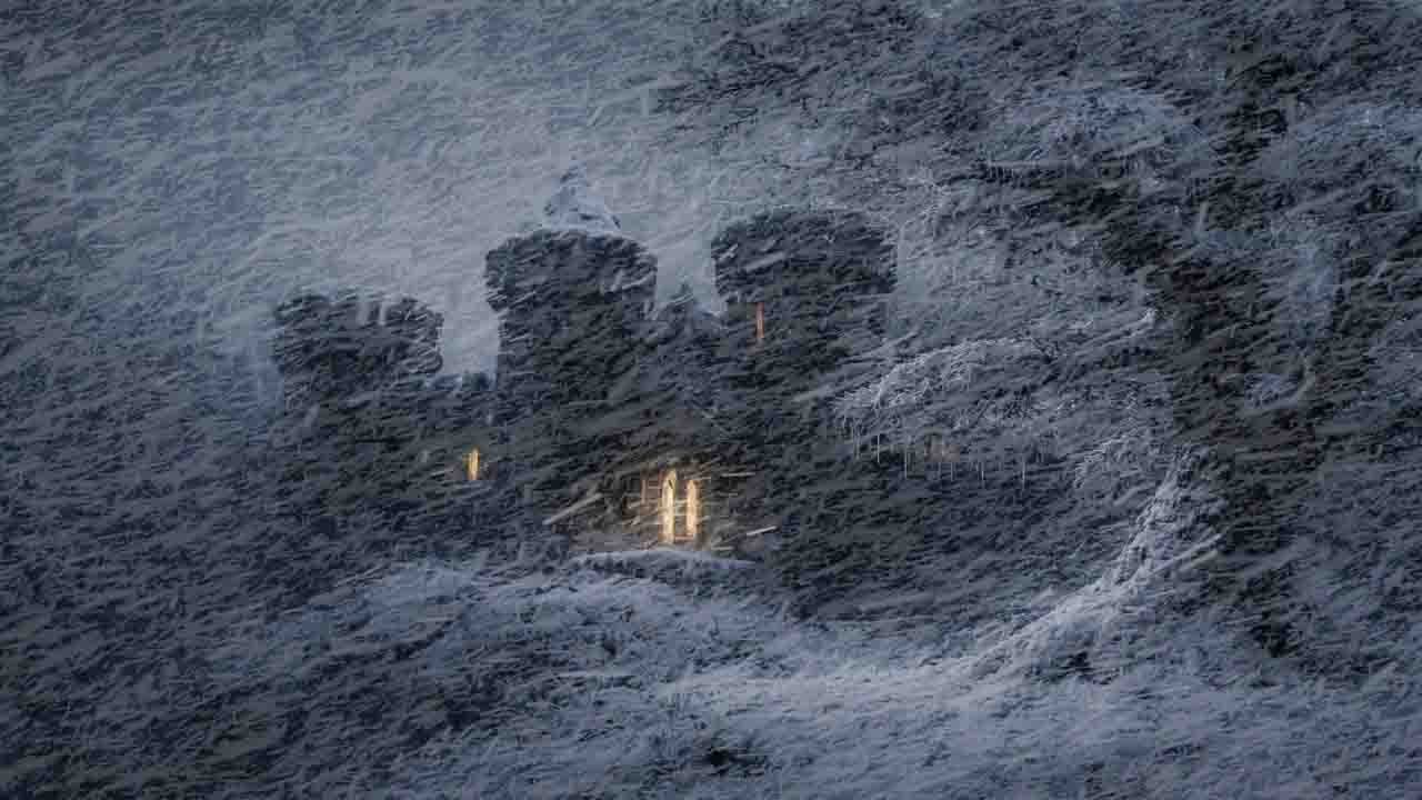 A blizzard outside | A stormy atmosphere surrounds a lonely, ancient castle.