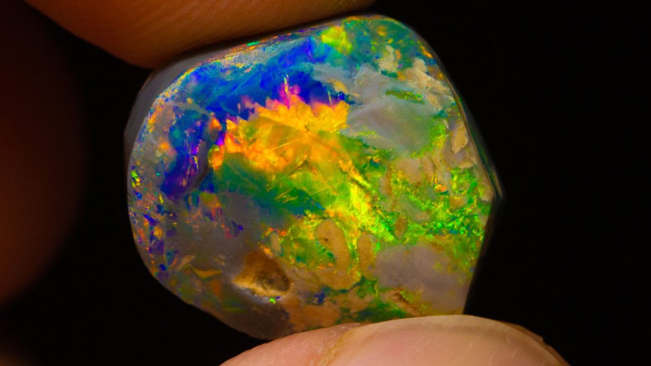 $20k gem black opal emerges from this uncut rough opal