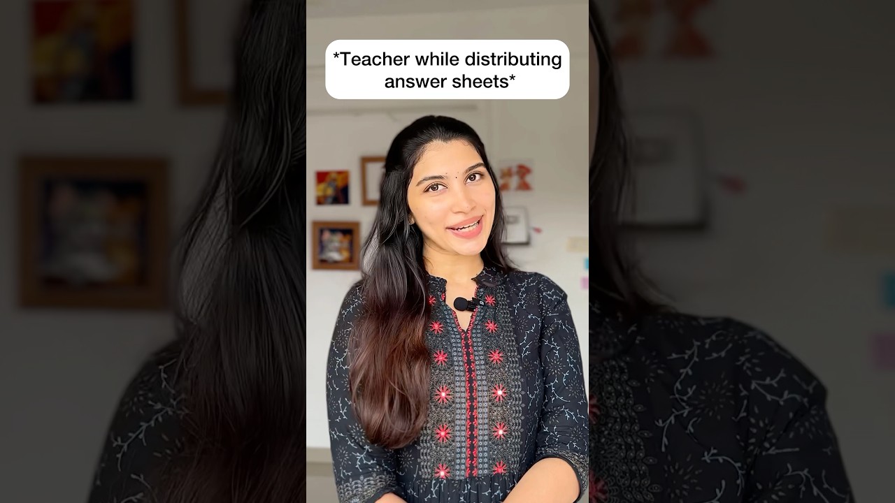 Teacher while distributing answer sheets 