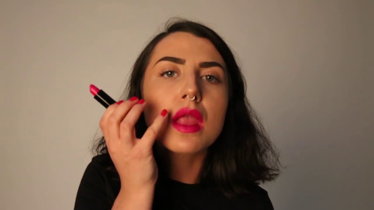 Applying Pink Lipstick