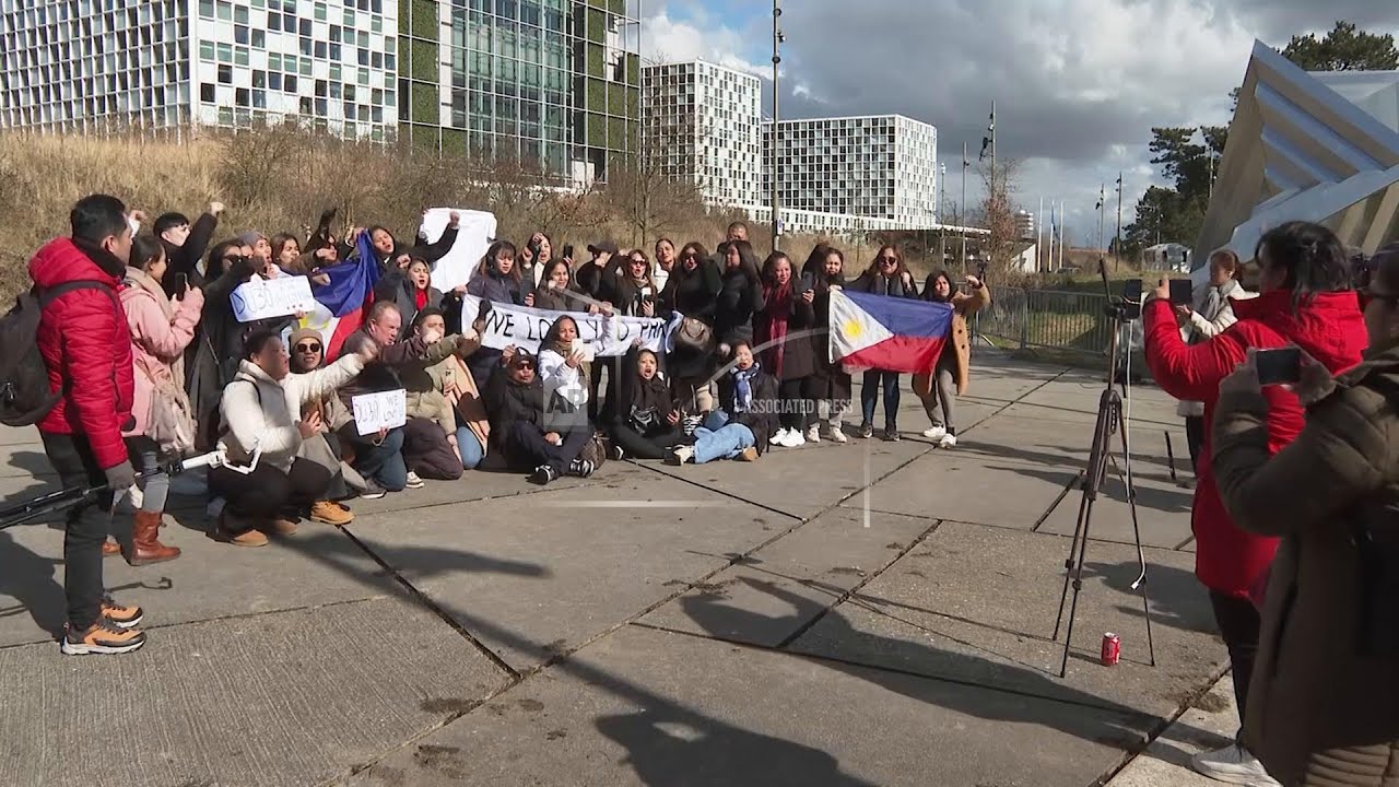 Protesters gather outside the ICC with Duterte expected to make his first appearance