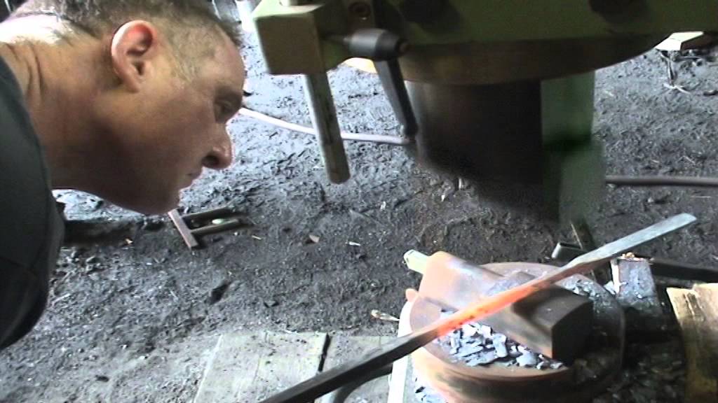 Blacksmith Ian Parmenter forges a ram's-head poker