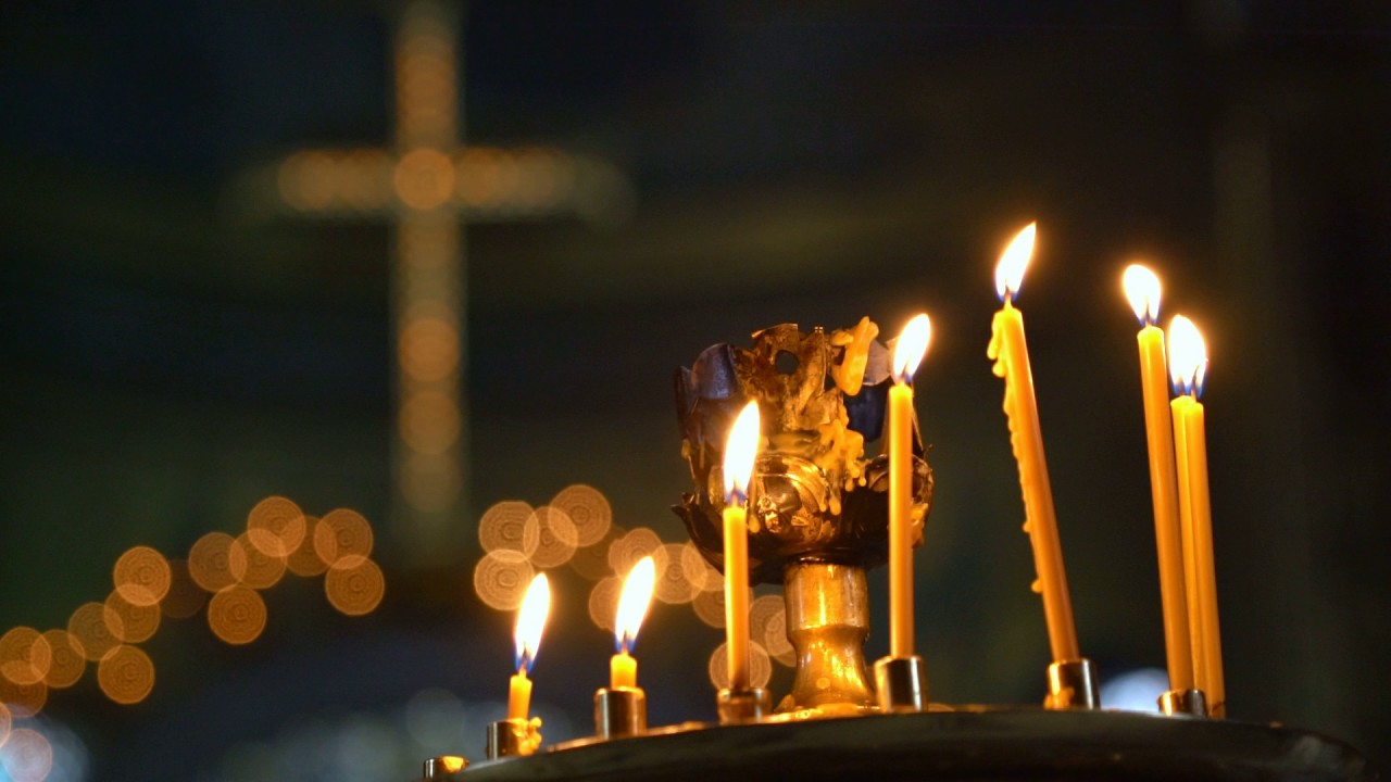 Candles Burning in the Orthodox Cathedral. the Wax Melts and Flows Down on the Bottom of the Candle