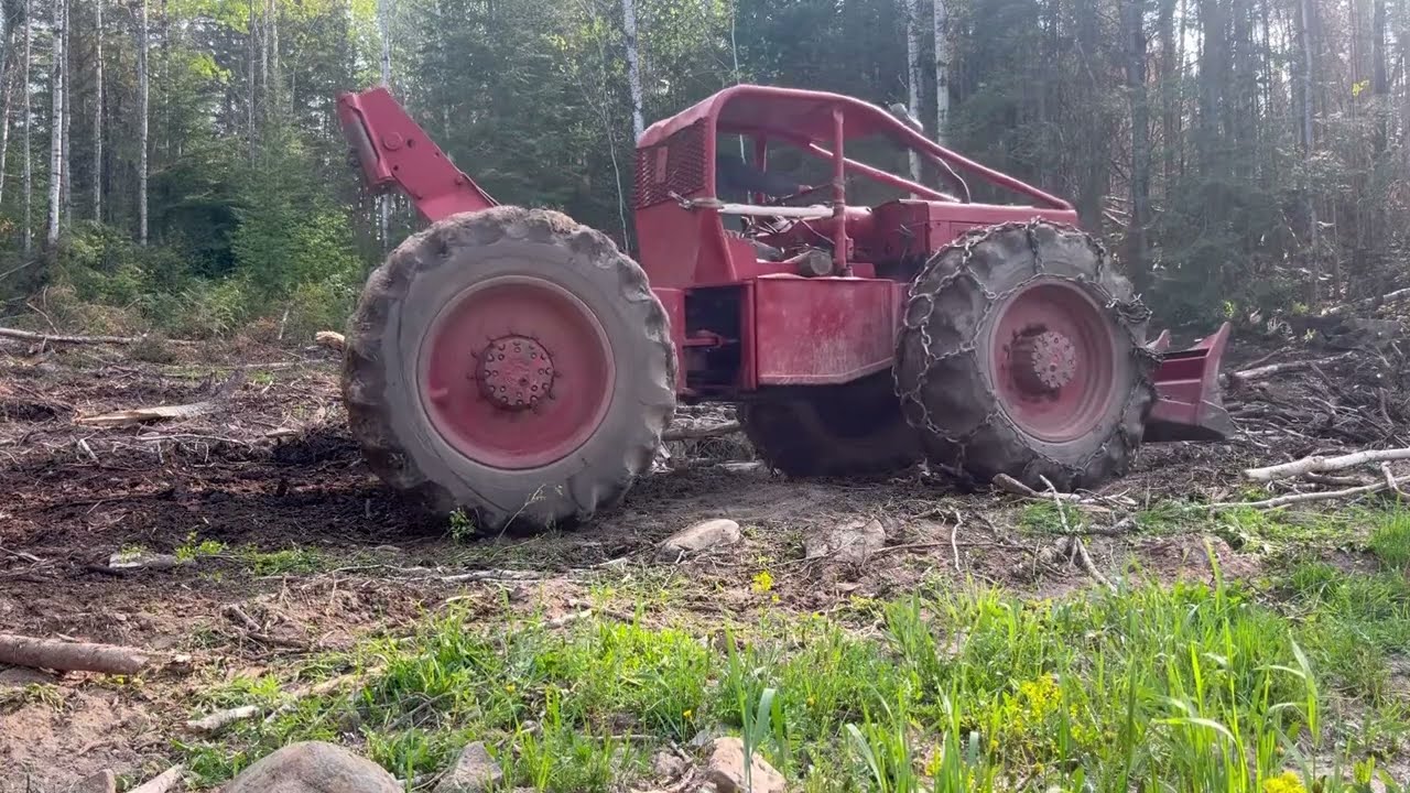 Old log skidder. Timberjack 230 with 353 Detroit diesel running in the woods