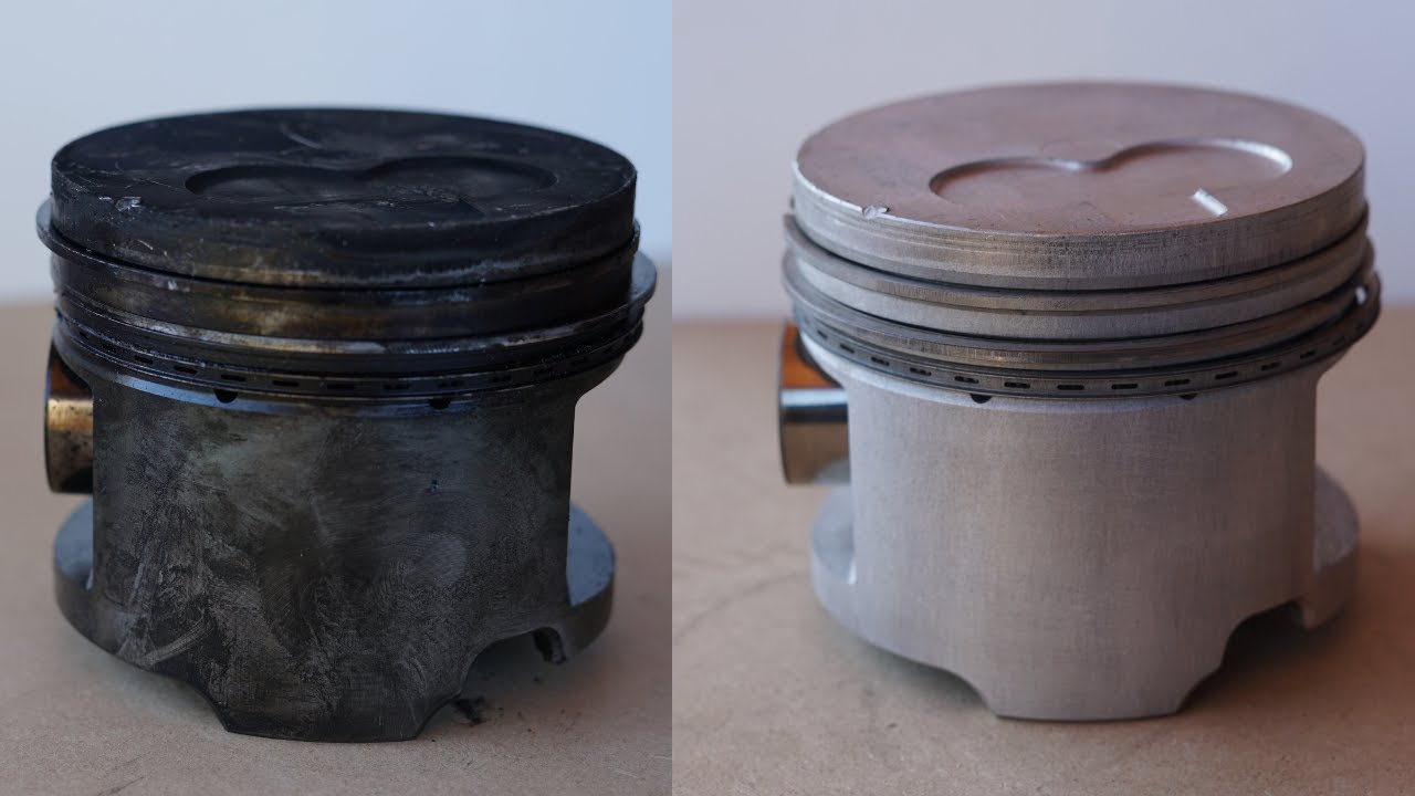 Laser removal of carbon buildup on a piston