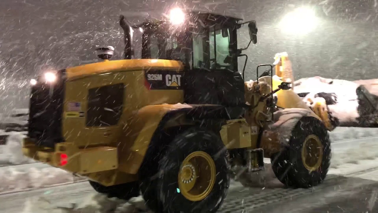Cat 926M loader plowing wet heavy snow