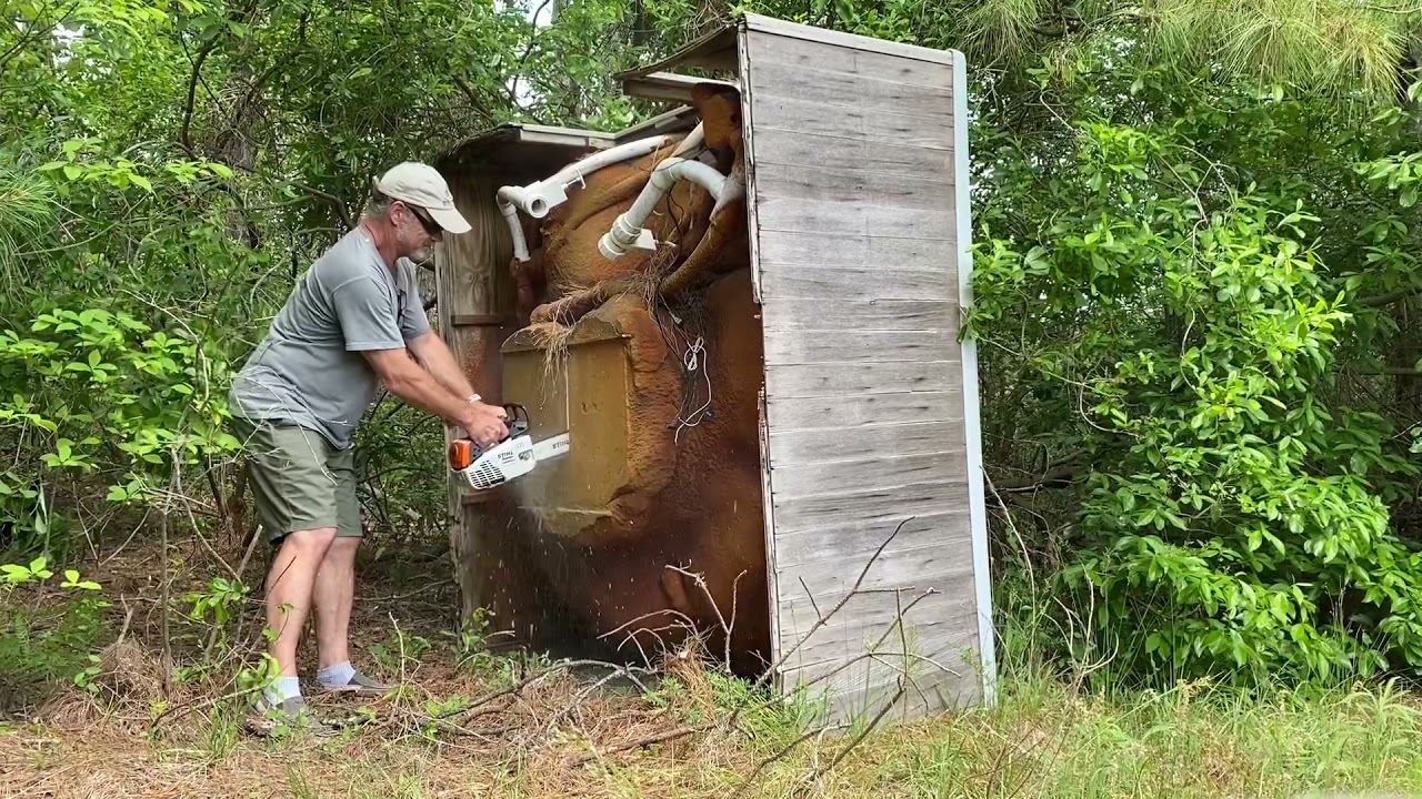 OLD MAN TEARING APART a hot tub with a chainsaw.