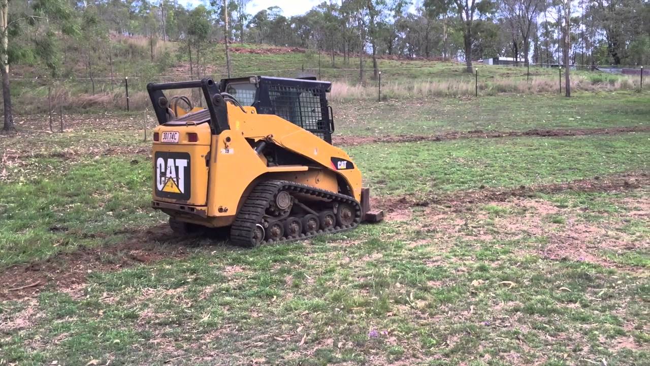 Swale building with Cat 257b skid steer loader