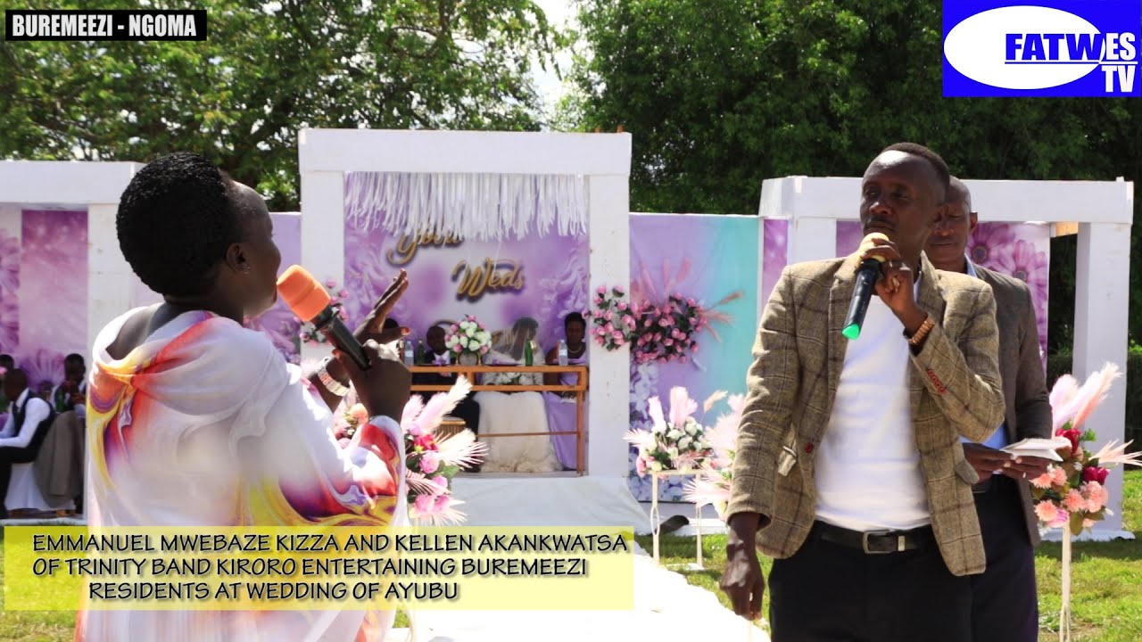 EMMANUEL MWEBAZE KIZZA AND KELLEN AKANKWATSA OF TRINITY BAND KIRORO ENTERTAINING BUREMEEZI RESIDENTS