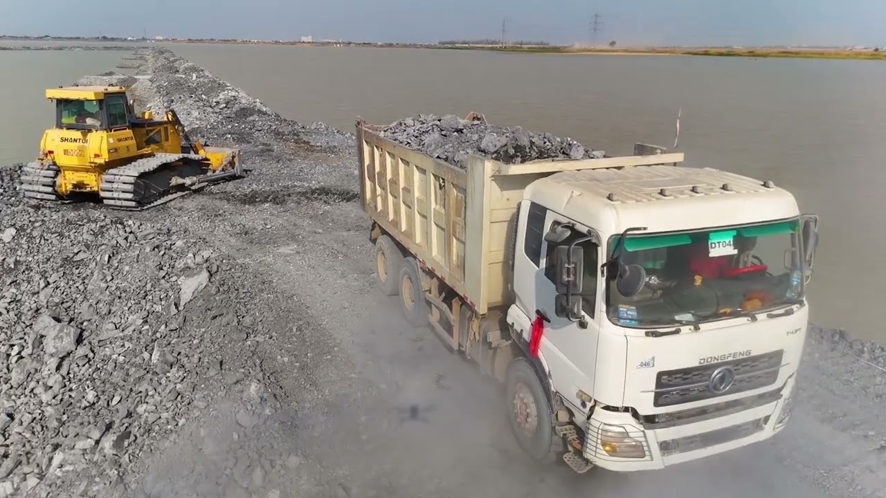 EP06,Fantastic road project Use a truck,wheel loaderand a Dozer Shantui to dump rocks into a sizabl