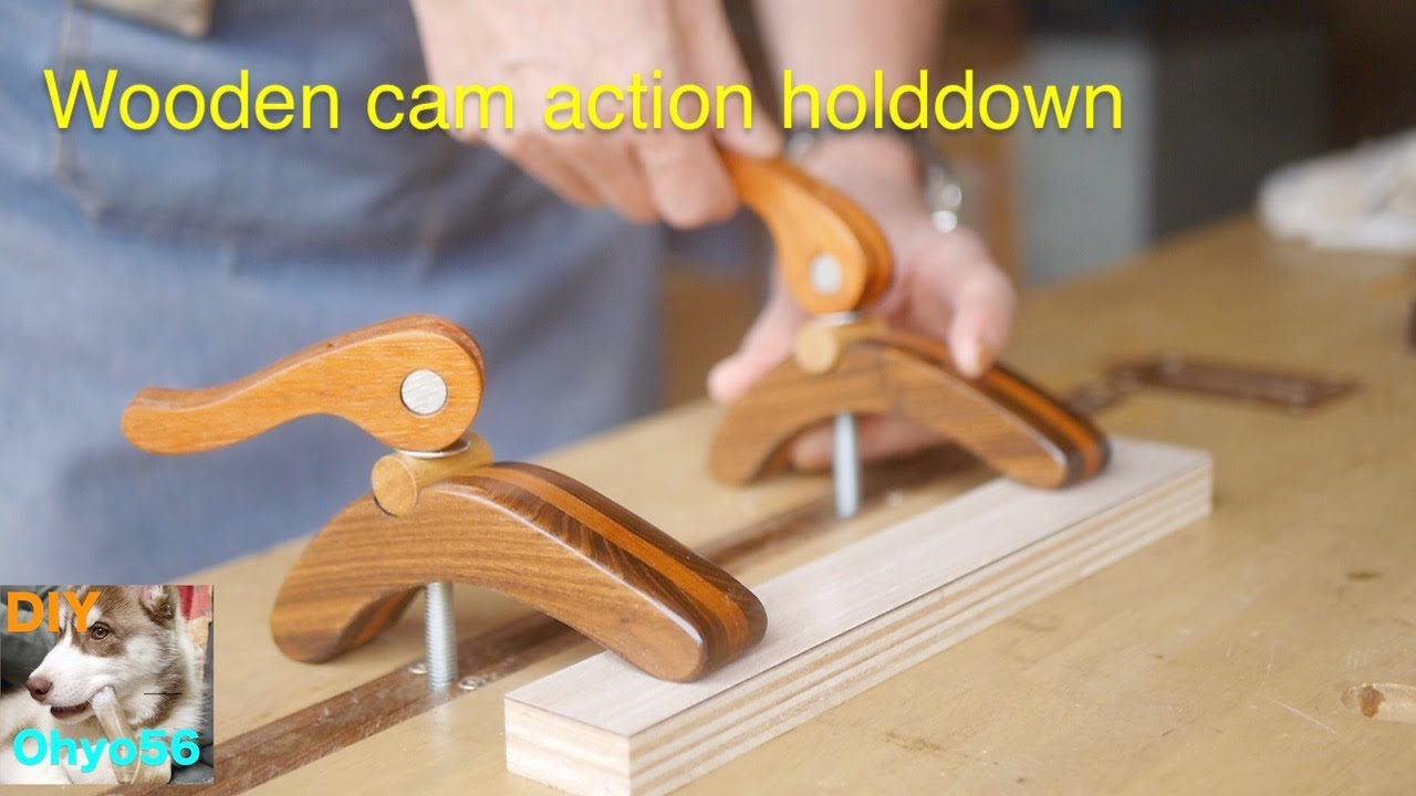 Wooden cam action holddown