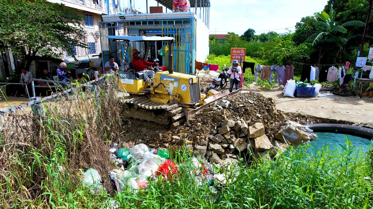 Amazing bulldozer push the big stone cover the trash into the flood and kindly dump truck cooperate