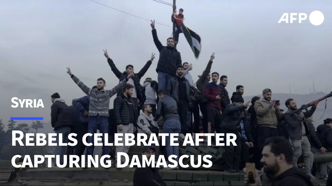 Rebels celebrate in Umayyad Square in Syria's Damascus | AFP