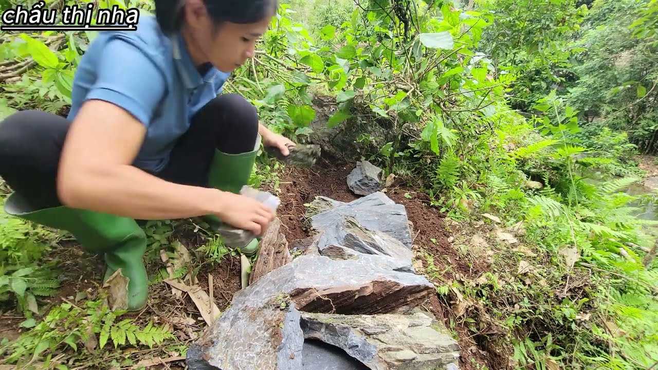 Smashing stones and leveling the ground to decorate the house with flowers