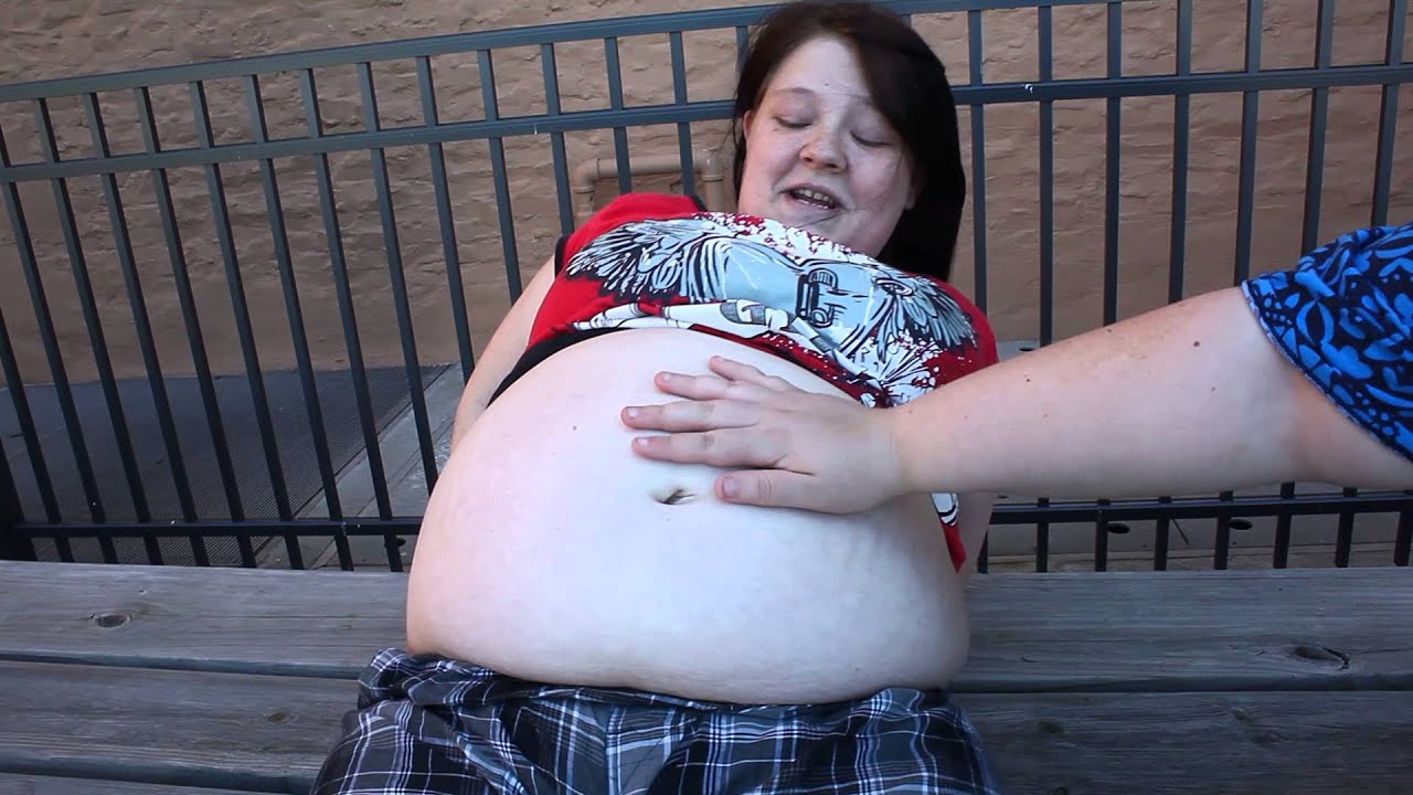 Pregnant girl with a ticklish belly button