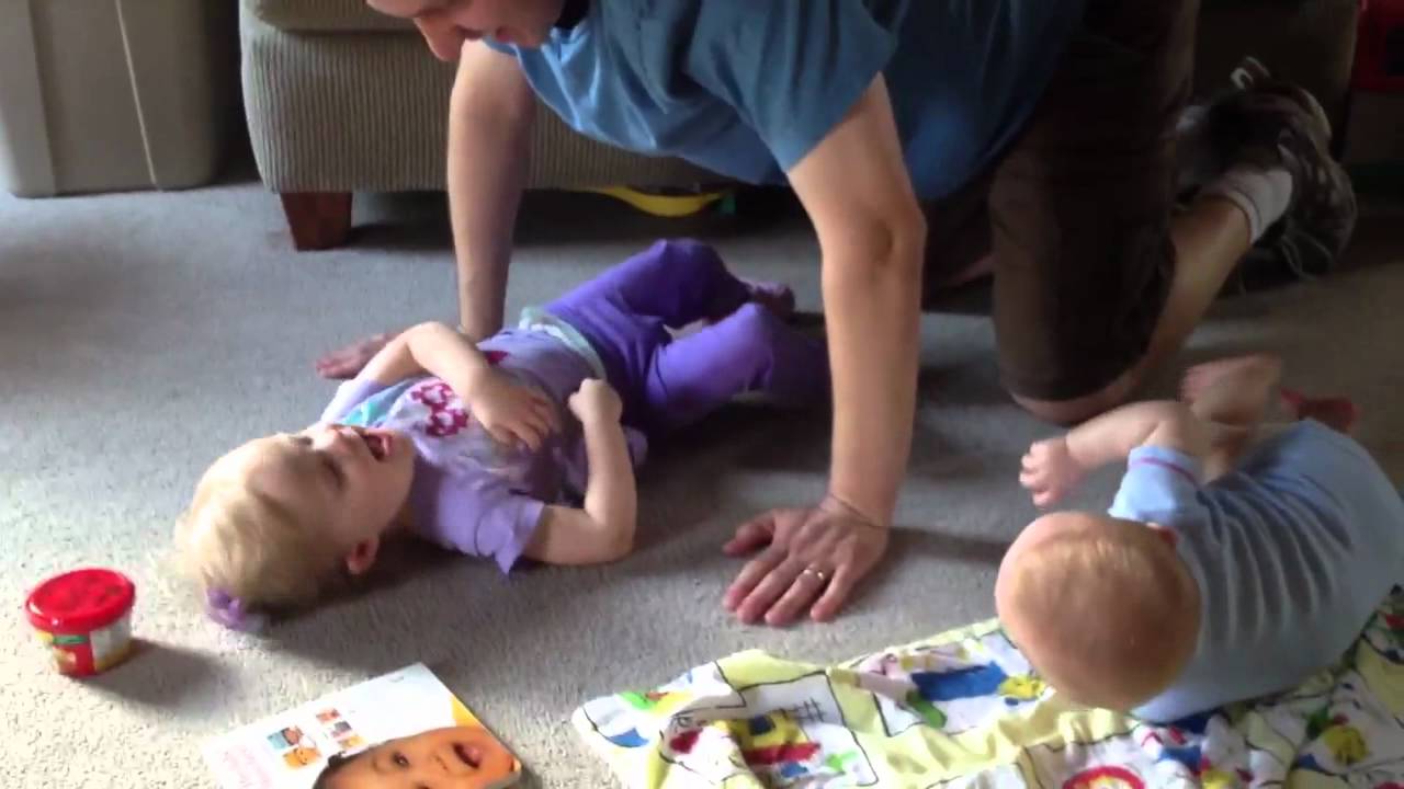 Daddy tickling kids