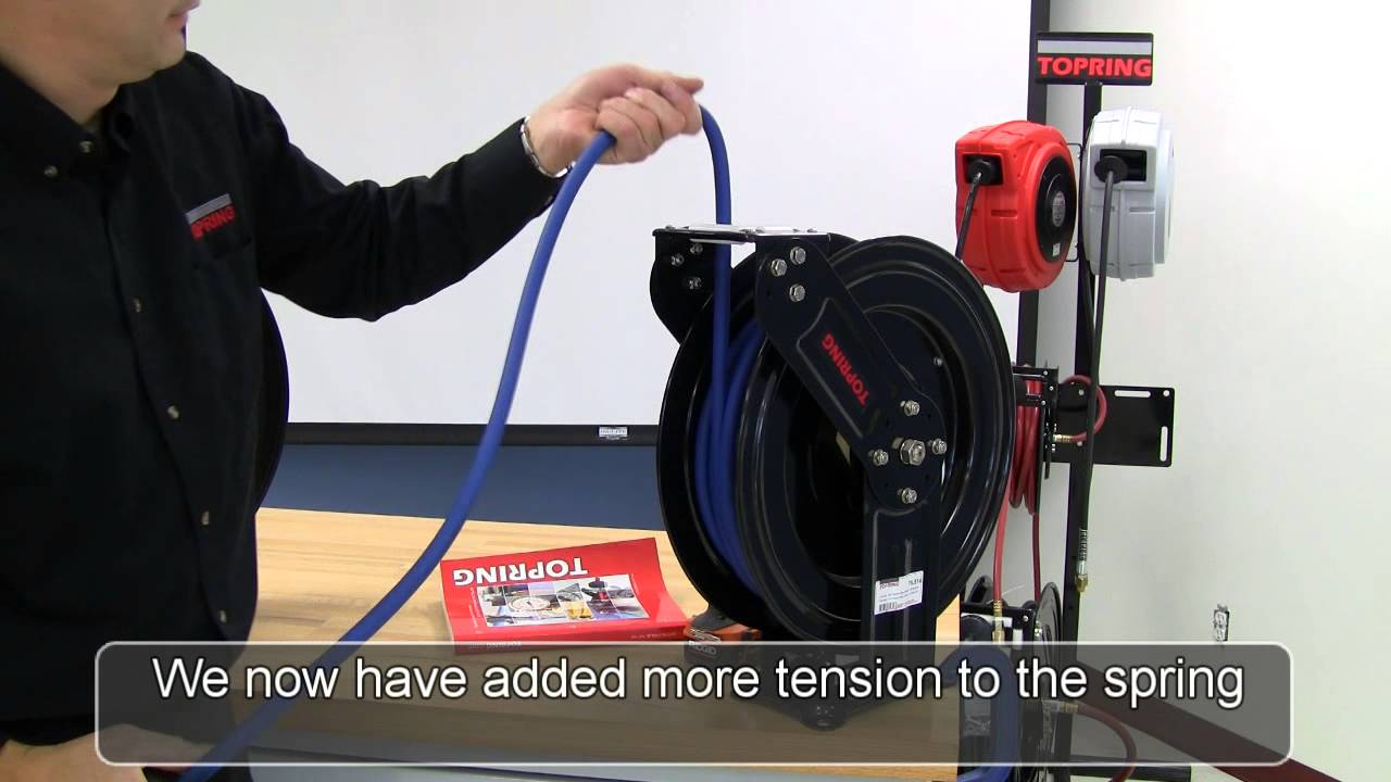Spring tension adjustment on a hose reel with two arms