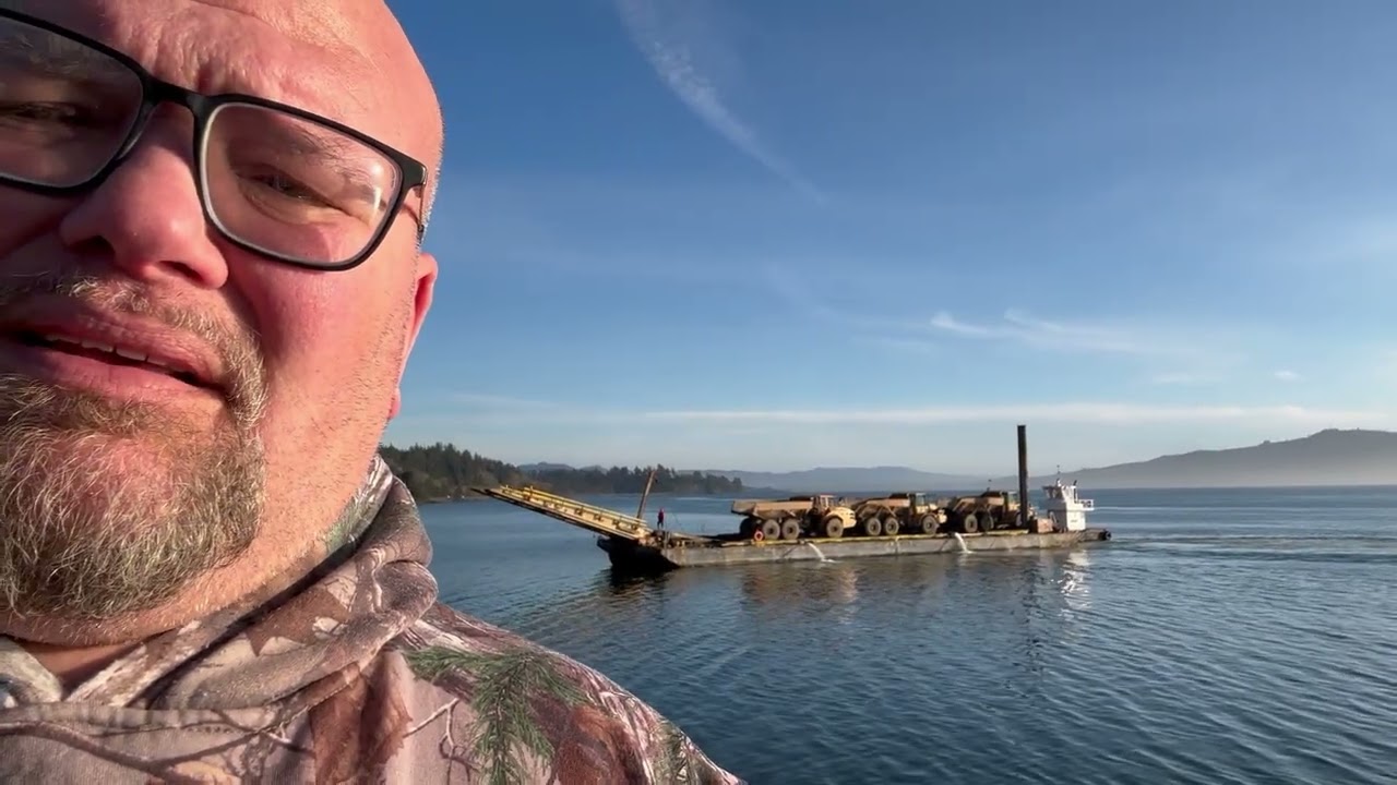 The barge coming in to haul rocks to the jetty.