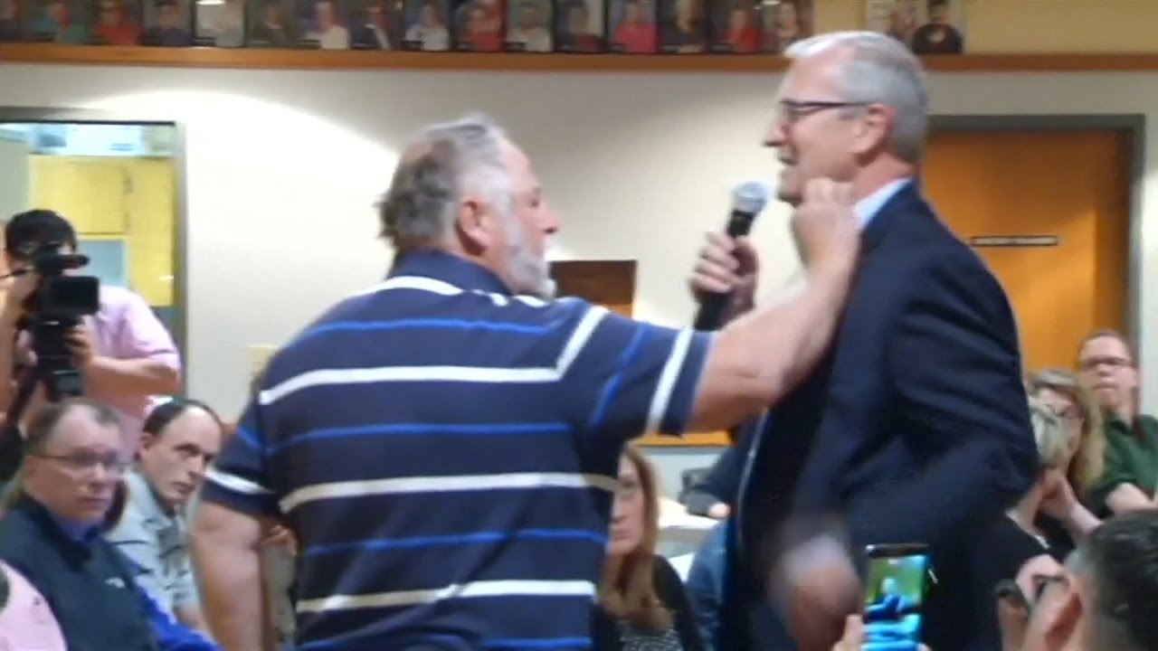 Watch a man stuff money in a GOP congressman's shirt at a heated North Dakota town hall