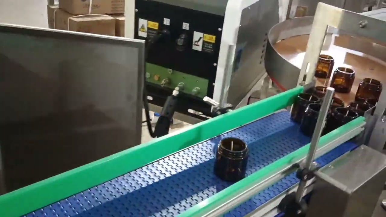 Automatic candle wick gluing machine for amber glass jar with lid