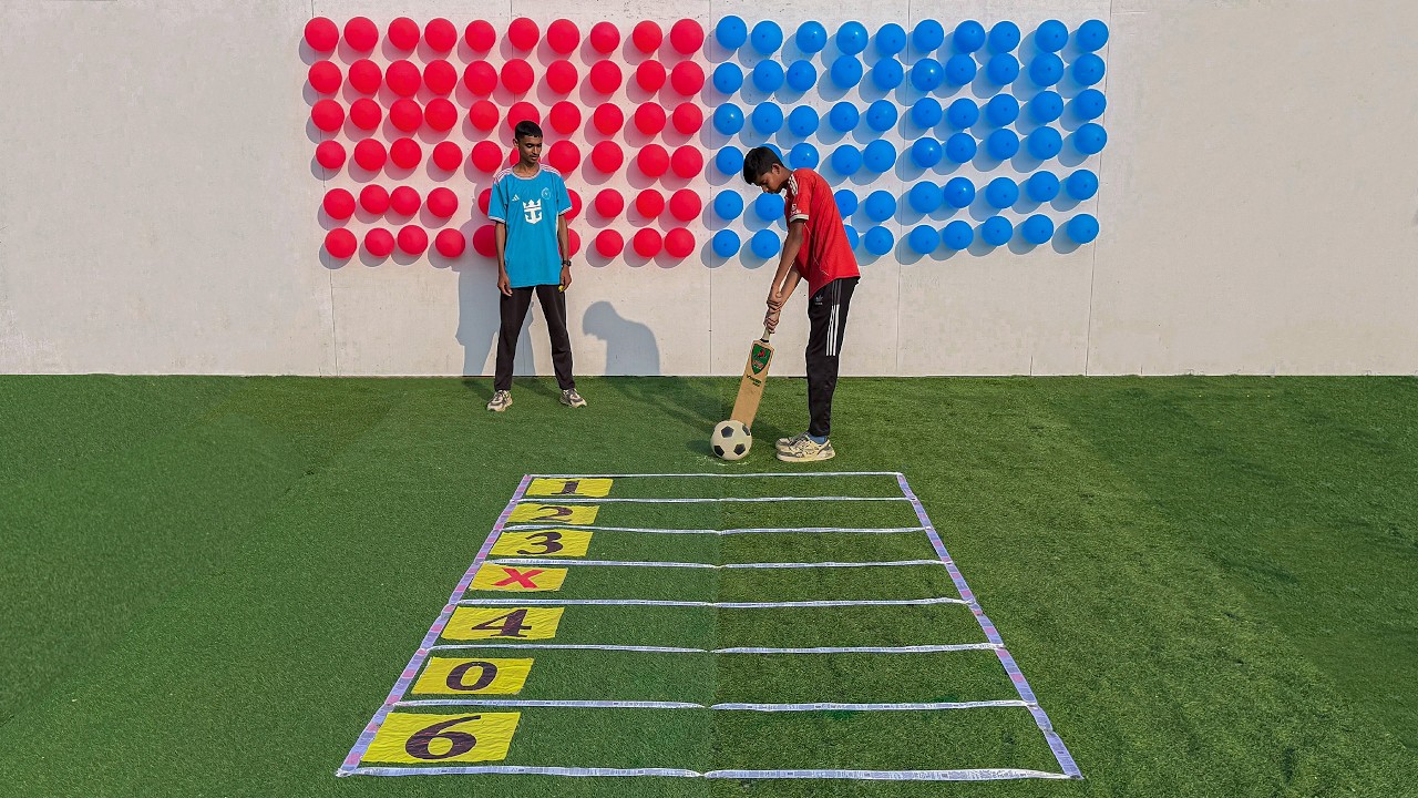 Who will score 60 points first by hitting the football ? 