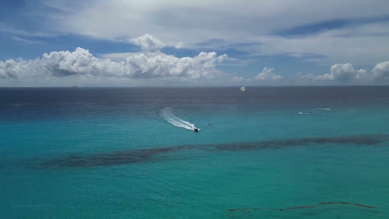 Sunny Beach day at  Riu Palace Riviera Maya watching the Parasailers , jet skis, and boaters!