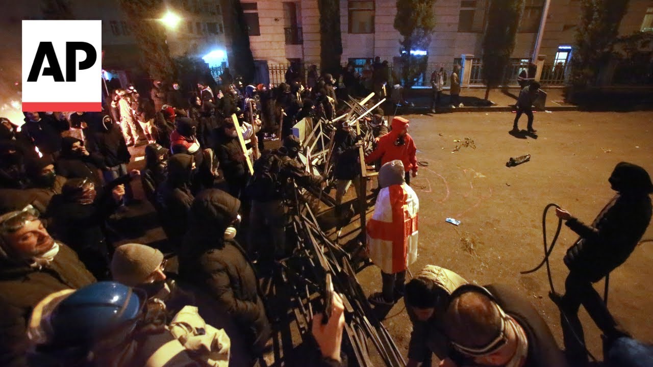 Riot police try to disperse a large crowd in Tbilisi's center