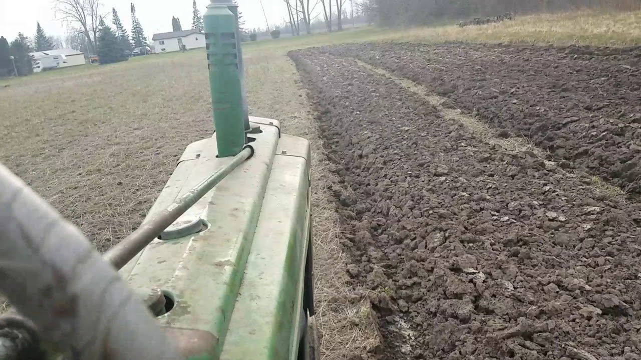 John deere b plowing