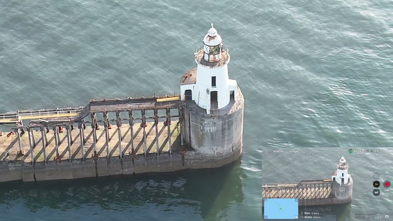 South Beach Blyth Northumberland and West Pier river mouth drone with early sun flat sea